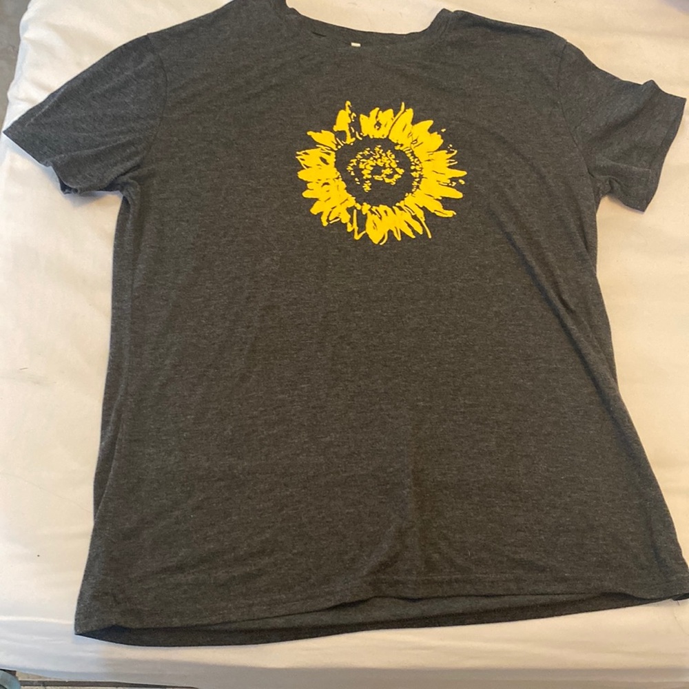 A large grey t shirt with a yellow sunflower print